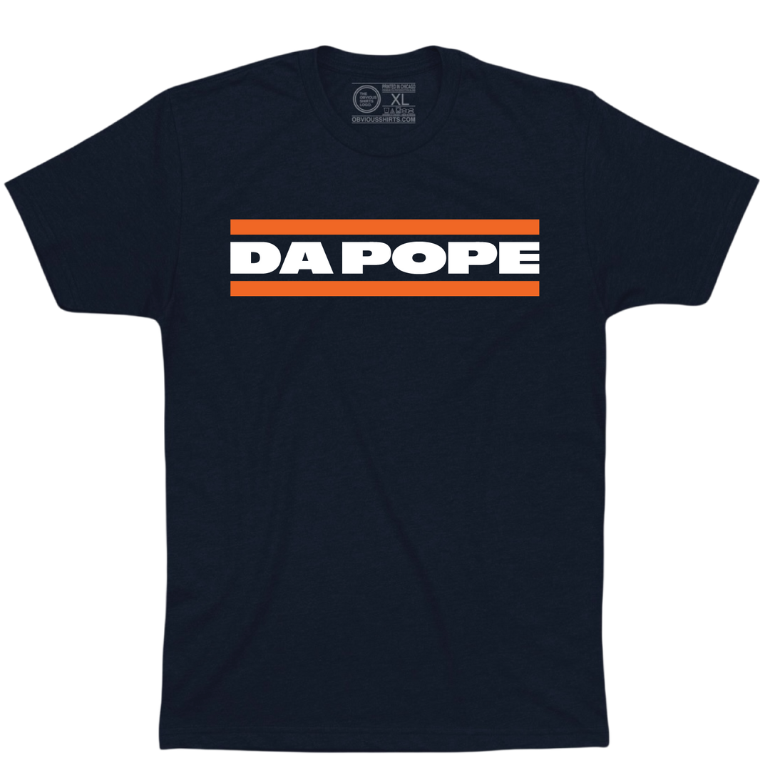 Navy Da Pope T-shirt with bold white lettering between two orange stripes.
